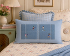 Blue Pickleball Court pillow on a floral bed beside a pink lamp.