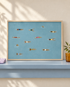Beneath The Surface blue swimmers art in an oak frame on a powder-blue shelf; lifestyle visualisation