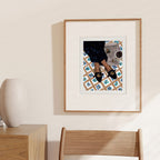 News For Breakfast art print with a wide white mount above a wooden chair.
