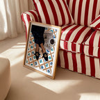 News For Breakfast framed art print beside a red and white striped armchair.