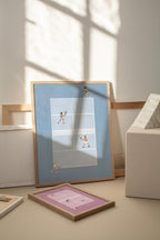 Blue Doubles Delight I framed tennis print beside a window and a smaller pink print.