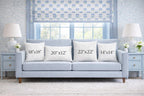 Pillow size comparison showing 18 by 18, 20 by 12, 22 by 22 and 14 by 14 inch cushions on a sofa.