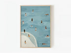 Golden Days beach and swimmers art print in a natural wood frame on a white wall.