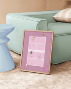 Pink Doubles Delight framed tennis art leaning against a pale green sofa.