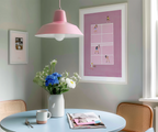 Pink Doubles Delight framed tennis print above a dining table with flowers.