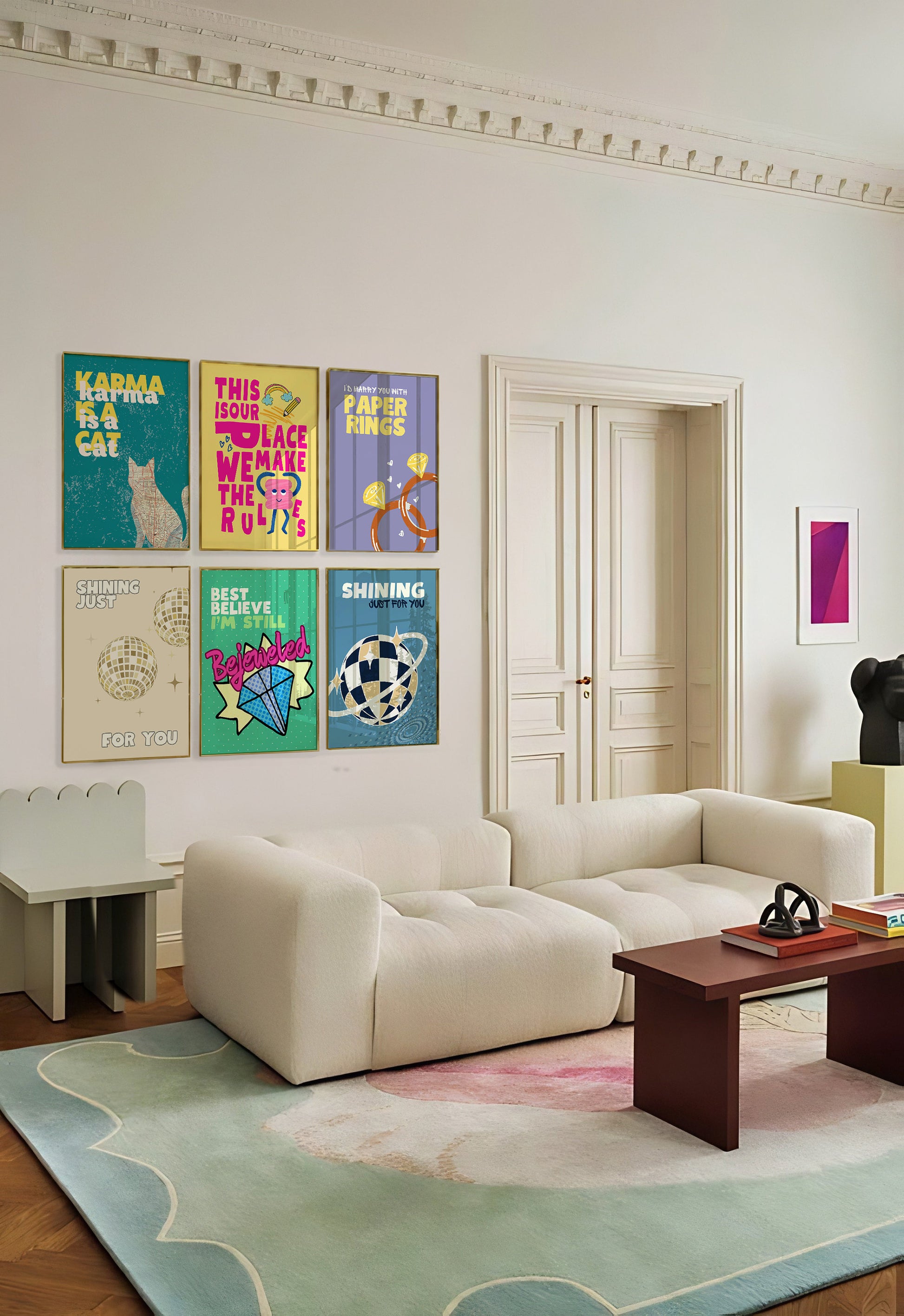 a living room filled with furniture and paintings on the wall