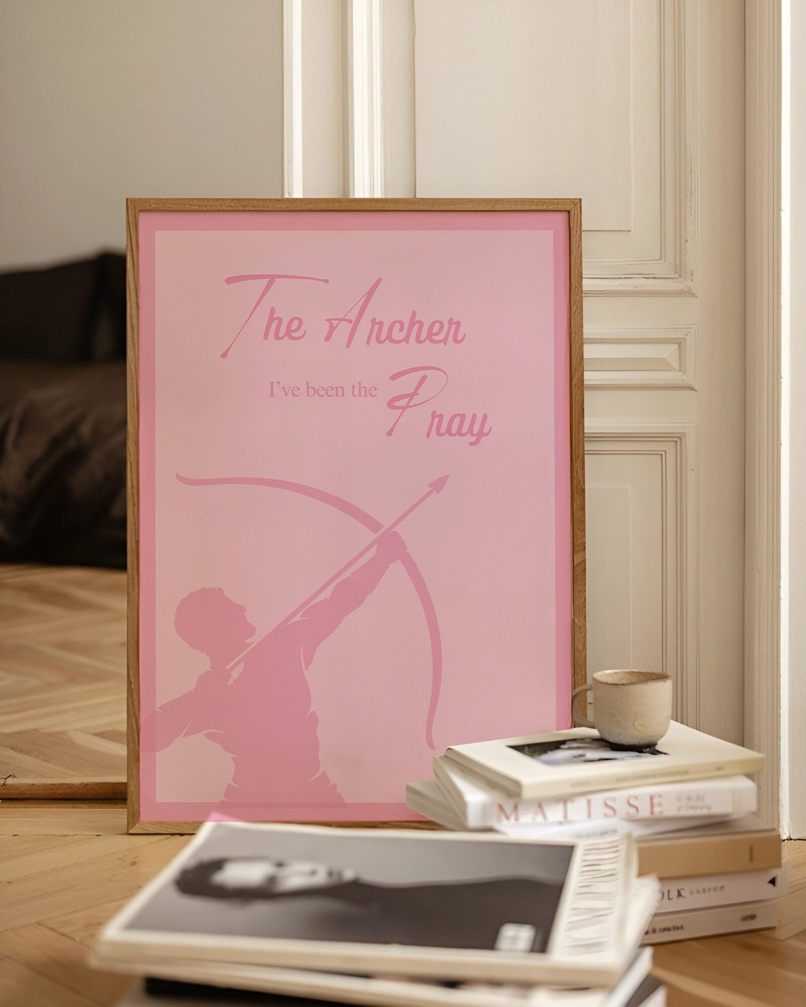 a pink poster sitting on top of a wooden floor